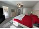 Bright main bedroom with an open ensuite bathroom, large bed, neutral colors, and carpet floors at 4161 Dean Grove Way, Loganville, GA 30052