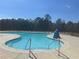 Community pool showcasing crystal-clear water, safety signage, and inviting lounge area at 4161 Dean Grove Way, Loganville, GA 30052
