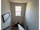 A charming stairway landing with decor and a window allowing natural light at 4161 Dean Grove Way, Loganville, GA 30052