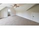 Spacious bedroom with neutral carpet, ceiling fan, and attic access door at 46 Lexie Ct, Rockmart, GA 30153