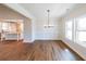 Dining area showcasing elegant wainscoting, modern light fixture, and view to the kitchen at 46 Lexie Ct, Rockmart, GA 30153