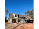 Rear view of new construction home featuring attached garage and gravel driveway on a sunny day at 46 Lexie Ct, Rockmart, GA 30153