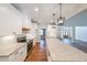 Well-lit kitchen features white cabinets, granite countertops, stainless steel appliances, and an expansive center island at 46 Lexie Ct, Rockmart, GA 30153