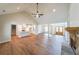Open-concept living room showcasing hardwood floors, vaulted ceilings, and a stone fireplace at 46 Lexie Ct, Rockmart, GA 30153