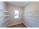 Walk-in pantry featuring wooden floors, white wire shelving, and a window that provides natural lighting at 46 Lexie Ct, Rockmart, GA 30153