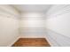 A well-organized walk-in closet with white wire shelving and hardwood floors at 46 Lexie Ct, Rockmart, GA 30153