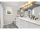 Modern bathroom featuring a double vanity, striking tile flooring, and natural light from the window at 759 Reeves Lake Sw Dr, Marietta, GA 30064