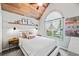 Comfortable bedroom featuring vaulted wood ceilings, a large window, and neutral decor at 759 Reeves Lake Sw Dr, Marietta, GA 30064