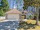 Charming single-story home with a well-manicured lawn and two-car garage, nestled amongst mature trees at 759 Reeves Lake Sw Dr, Marietta, GA 30064