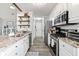 Bright kitchen with granite counters, stainless steel appliances, and ample cabinet space at 759 Reeves Lake Sw Dr, Marietta, GA 30064