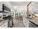Gourmet kitchen featuring granite countertops, stainless steel appliances, and an open dining area at 759 Reeves Lake Sw Dr, Marietta, GA 30064