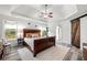 Elegant main bedroom with tray ceiling, stylish decor, and a sliding barn door to the bathroom at 759 Reeves Lake Sw Dr, Marietta, GA 30064