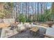 Inviting outdoor patio featuring comfortable seating, a dining area, and a lush backyard at 759 Reeves Lake Sw Dr, Marietta, GA 30064