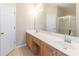 Bathroom featuring a double sink vanity, neutral walls, and a glass enclosed shower at 1062 Glen Chase Dr, Lawrenceville, GA 30044