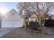 Charming home featuring a two-car garage, mature tree, and well-maintained lawn at 1062 Glen Chase Dr, Lawrenceville, GA 30044