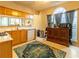 Bright kitchen with lots of natural light and wood cabinets and a large area rug at 1062 Glen Chase Dr, Lawrenceville, GA 30044