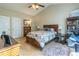 Comfortable bedroom featuring a ceiling fan, large window, and a wooden bed frame at 1062 Glen Chase Dr, Lawrenceville, GA 30044