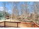 Backyard view from wooden deck featuring mature trees and green space at 145 Windward Hls, Mcdonough, GA 30253