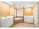 Bathroom featuring tile floor, white cabinets, double sinks, soaking tub and natural light at 145 Windward Hls, Mcdonough, GA 30253