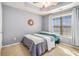 Cozy bedroom with gray walls, carpet, tray ceiling, and large window with window coverings at 145 Windward Hls, Mcdonough, GA 30253