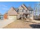 Charming brick two-story home with well-manicured lawn and attached two-car garage at 145 Windward Hls, Mcdonough, GA 30253