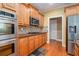 Well-lit kitchen featuring wood cabinets, stainless steel appliances, and granite countertops at 145 Windward Hls, Mcdonough, GA 30253