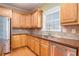 Inviting kitchen area with wooden cabinets, stainless steel appliances, and wood flooring at 145 Windward Hls, Mcdonough, GA 30253