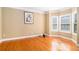 Sunlit living room featuring hardwood floors, neutral walls, and large windows at 145 Windward Hls, Mcdonough, GA 30253