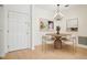 Dining room features a modern chandelier, round wood table with seating, and contemporary art at 2921 Lenox Rd # 308, Atlanta, GA 30324