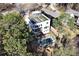 Aerial shot of modern home surrounded by lush greenery, featuring a rooftop deck and swimming pool at 412 Ashwood Sw Ave, Atlanta, GA 30315