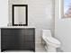 Well-lit bathroom featuring modern vanity, marble countertop, and toilet at 412 Ashwood Sw Ave, Atlanta, GA 30315