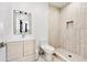 Bathroom featuring modern vanity, toilet, and tiled shower with a niche at 412 Ashwood Sw Ave, Atlanta, GA 30315