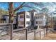 Modern home showcasing a multi-story design with a stairway, fenced yard, and contemporary finishes at 412 Ashwood Sw Ave, Atlanta, GA 30315