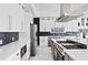 Modern kitchen with white cabinets, stainless steel appliances and dark backsplash at 412 Ashwood Sw Ave, Atlanta, GA 30315