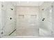 Luxurious shower with dual shower heads, marble tile, frameless glass doors, and linear drain at 412 Ashwood Sw Ave, Atlanta, GA 30315