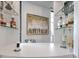 Custom bar area features glass shelves and a painting at 75 14Th St # 4140, Atlanta, GA 30309