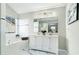 Bright bathroom featuring double vanity, large mirror, bathtub and a large window at 885 Clairidge Ln, Lawrenceville, GA 30046