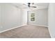 Neutral bedroom with plush carpet and large window that overlooks the yard at 885 Clairidge Ln, Lawrenceville, GA 30046