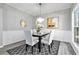 Formal dining room with modern chandelier, large windows, and stylish decor at 885 Clairidge Ln, Lawrenceville, GA 30046