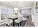 Elegant dining area boasting stylish lighting, wainscoting and large windows at 885 Clairidge Ln, Lawrenceville, GA 30046