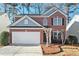 Charming brick home featuring a two-car garage and manicured landscaping at 885 Clairidge Ln, Lawrenceville, GA 30046