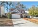 Two-story brick home featuring an attached garage and a long driveway at 885 Clairidge Ln, Lawrenceville, GA 30046