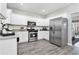 Well-lit kitchen features stainless steel appliances, granite countertops, and white cabinetry at 885 Clairidge Ln, Lawrenceville, GA 30046