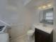 Bright bathroom with updated vanity, lighting, toilet, and fixtures; also has a hidden laundry at 2217 Troutdale Dr, Decatur, GA 30032