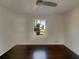 Bright bedroom featuring a modern ceiling fan, hardwood floors, and a large, sunlit window at 2217 Troutdale Dr, Decatur, GA 30032