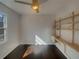 Bedroom with hardwood floors, built-in shelving, and a window; the natural light enhances the cozy interior at 2217 Troutdale Dr, Decatur, GA 30032