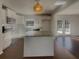 This is an open concept kitchen with white cabinets, stainless steel appliances, granite countertops, and hardwood floors at 2217 Troutdale Dr, Decatur, GA 30032