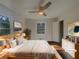 Staged main bedroom with light wood furniture, ceiling fan, and lots of natural light at 2217 Troutdale Dr, Decatur, GA 30032