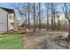 A portion of the backyard featuring mature trees, a partial lawn, and the rear side of the home at 290 Peachtree Se Dr, White, GA 30184