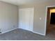 This bedroom features carpeted floors and a closet with bifold doors at 731 Hanover Se Ln, Marietta, GA 30067